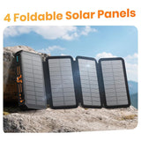 48000mAh solar power bank with 4 foldable solar panels unfolded, charging in direct sunlight on a rock
